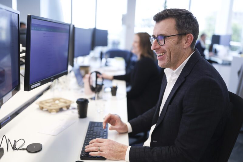 Greg Dennis at his desk in the North Sydney office